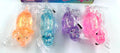 Stretchy glitter dinosaur squishy toys in orange, blue, purple and pink