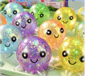 Glitter octopus squishy balls with smiling faces in purple, orange, yellow, green and blue